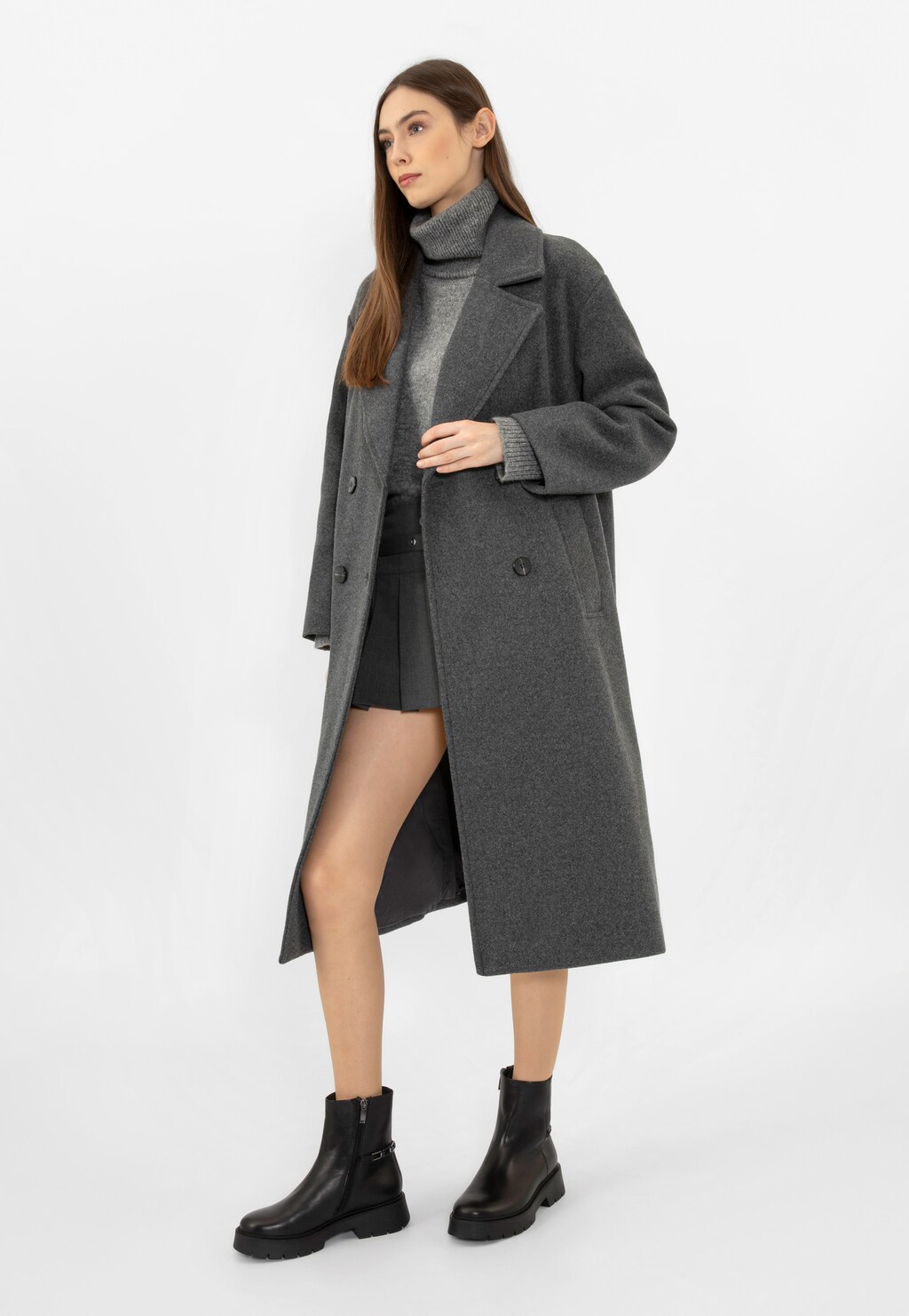 Model w szarym płaszczu i golfie, prezentująca czarne botki damskie Wojas 55231-51 ze skóry licowej z metalową ozdobą, idealne do zimowych stylizacji miejskich.