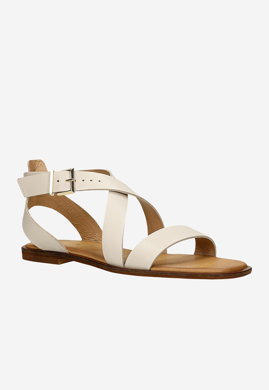 Beżowe sandały damskie Wojas model 76169-54 ze skóry licowej z krzyżującymi się paskami i złotą klamrą. Sandały mają płaską podeszwę z brązowym wykończeniem.