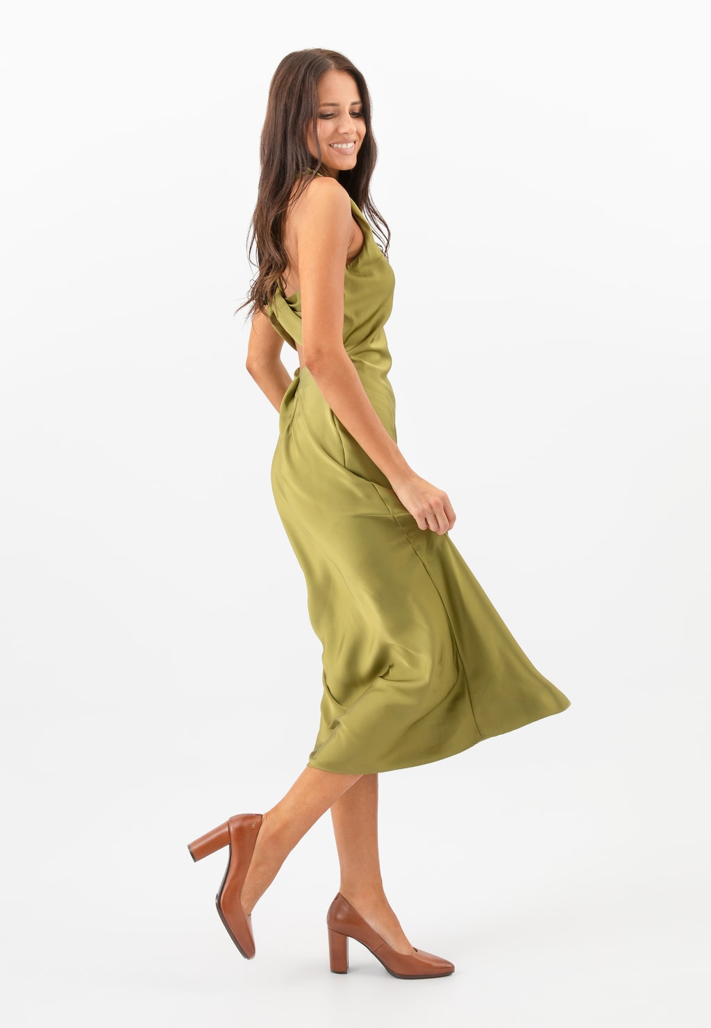 Elegancka modelka w oliwkowej sukience prezentuje brązowe czółenka Wojas ze skóry licowej model 35072-52 na stabilnym obcasie.