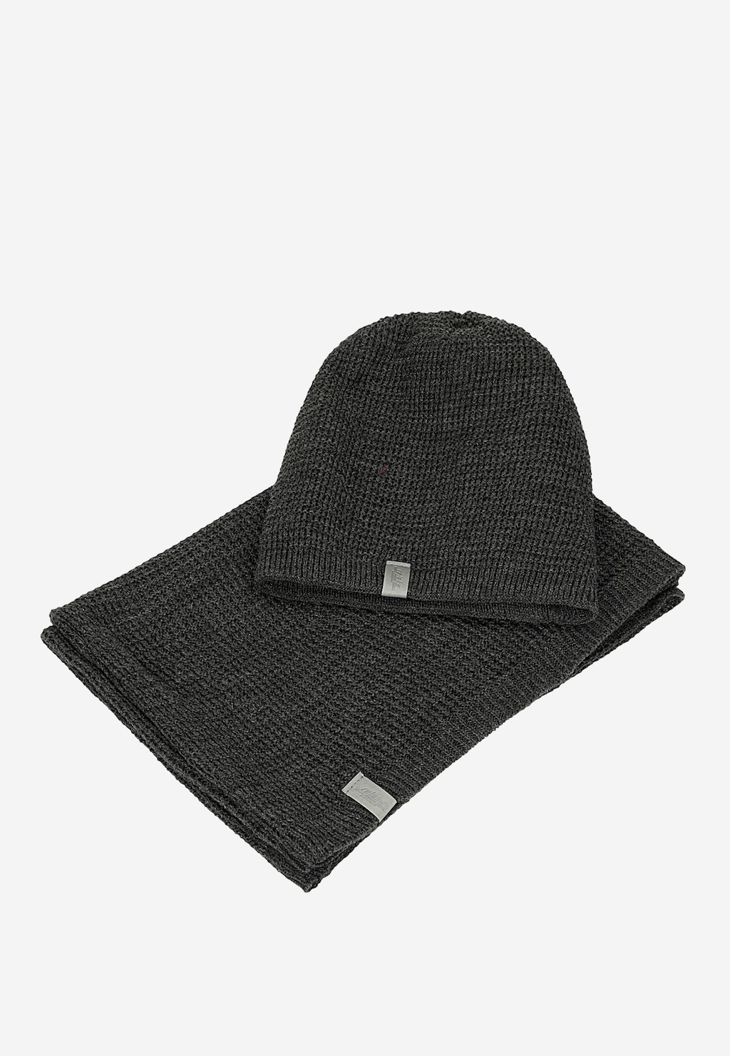 Popielaty komplet RELAKS składający się z dzianinowej czapki i komina model R96011-80. Oba elementy z metalowymi metkami marki, wykonane z ciepłego materiału.