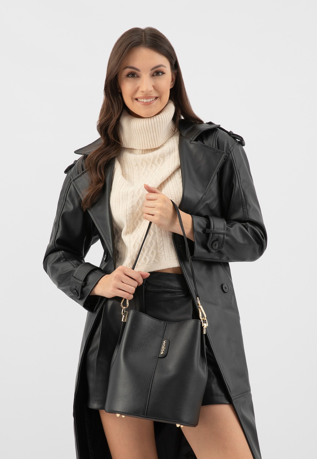 Elegancki jesienny strój z czarną skórzaną torebką damską Wojas model 80434-51 bucket bag. Stylizacja z czarnym płaszczem i kremowym golfem.