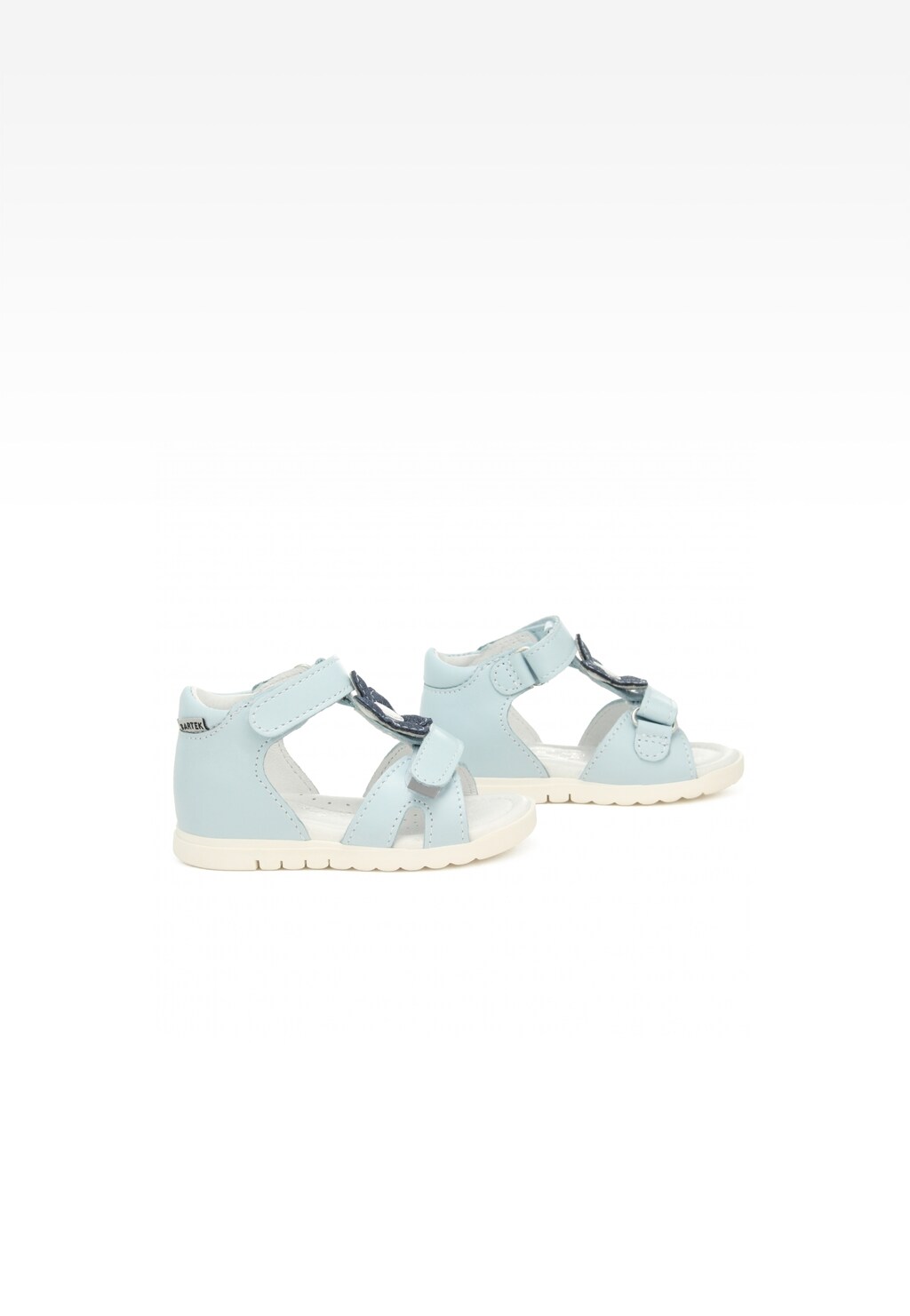 Jasnoniebieskie sandały dziecięce Bartek 11414001 dla dziewcząt z ozdobną kokardką, zapinane na rzepy, pokazane z boku na jasnej podeszwie.
